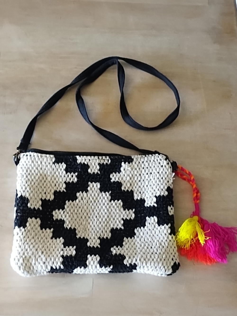 Black and Cream Woven Crossbody Bag with Bright Tassel Accent